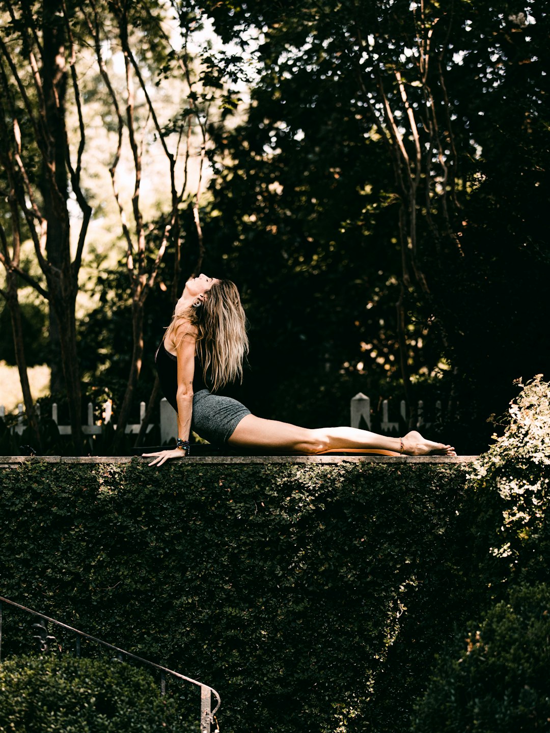 woman-in-black-tank-top-and-black-shorts-sitting-on-black-asphalt-road-during-daytime-vuqp4z9b9ac